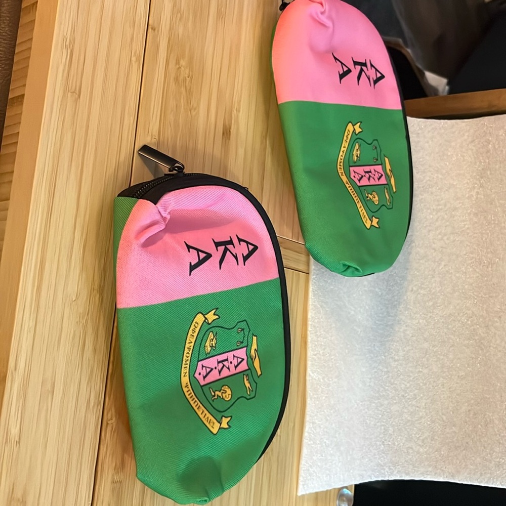 Two AKA bags, one 9 inch and one 7 inch, sorority bags